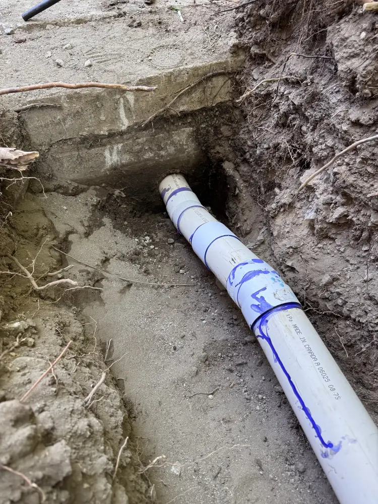New wastewater line connected carefully through a building foundation